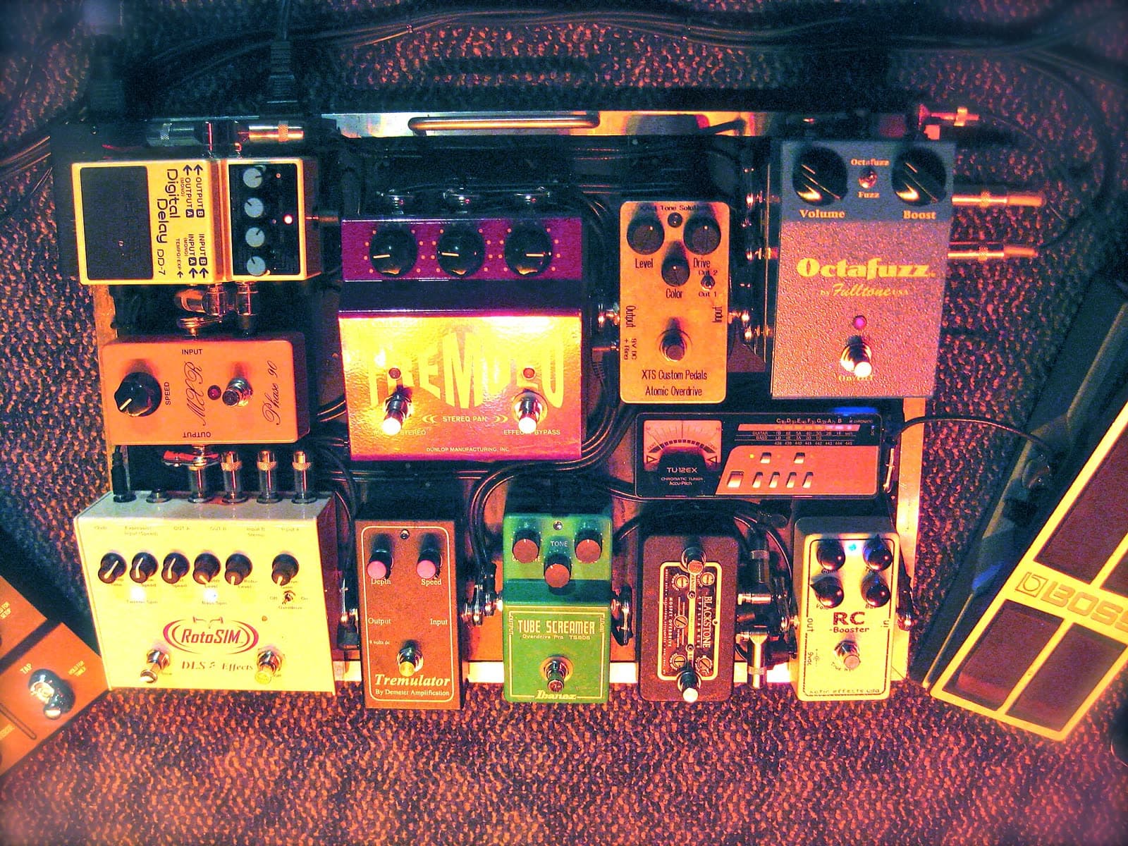 A pedalboard of effects pedals, seen from above